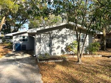 Charming single-story home featuring mature trees, side carport, and a classic design at 626 N Nashua Ave, Fort Meade, FL 33841