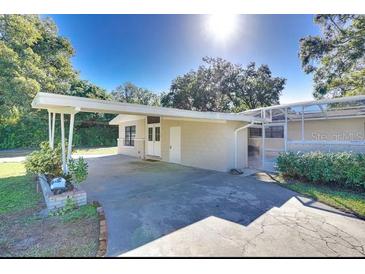 Inviting single-story home featuring a spacious carport and well-maintained landscaping at 919 Avenue S Se, Winter Haven, FL 33880