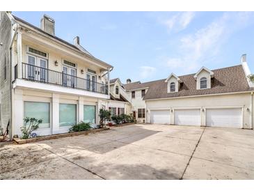Large two-story home with a three-car garage and a balcony at 926 S Lakeshore Blvd, Lake Wales, FL 33853