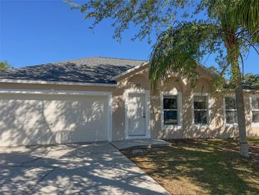Charming single-Gathering home with a well-maintained lawn, a two-car garage, and a welcoming front entrance at 1106 Partridge Way, Kissimmee, FL 34759