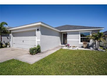 Charming single-story home featuring a well-manicured lawn and an attached two-car garage at 1108 Zion Dr, Haines City, FL 33844
