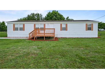 Charming single-story home featuring a cozy front porch and well-maintained lawn at 1302 Windsong Dr, Lakeland, FL 33811