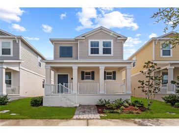 Charming two-story home with a cozy front porch and well-maintained landscaping at 1744 Cross Prairie Pkwy, Kissimmee, FL 34744