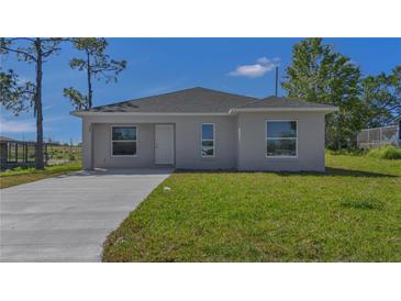 Charming single-story home featuring a well-maintained lawn and a concrete driveway at 225 Babson Dr, Babson Park, FL 33827