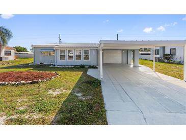 Charming single-story home with a carport and well-maintained front yard at 319 Thomas Ave, Frostproof, FL 33843