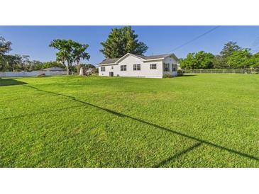 Quaint single-story home featuring a well-manicured lawn and a classic white exterior at 3736 Knights Station Rd, Lakeland, FL 33810