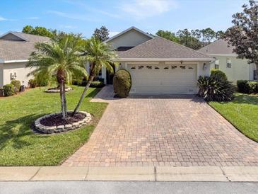 Charming single-story home with a brick driveway and well-maintained landscaping at 3905 Osprey Pointe Cir, Winter Haven, FL 33884