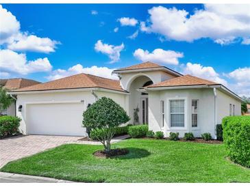 Charming single-story home with manicured lawn, brick driveway, and a two-car garage at 4088 Dunmore Dr, Lake Wales, FL 33859