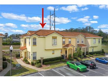 Inviting two-story townhome featuring a Spanish-tile roof and well-maintained landscaping in a neatly arranged community at 438 Monroe Cir, Davenport, FL 33896