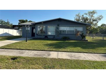 Charming single-story home featuring a well-manicured lawn, dark brick exterior, and a cozy, inviting curb appeal at 707 Great Barford St, Auburndale, FL 33823