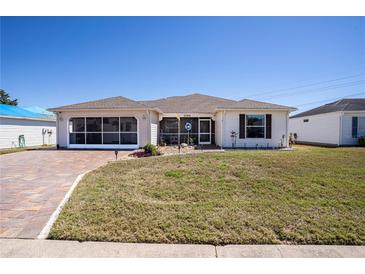 Charming single-story home featuring a brick driveway, screened in lanai, and well-maintained lawn at 1055 Canary S Cir, Lakeland, FL 33809