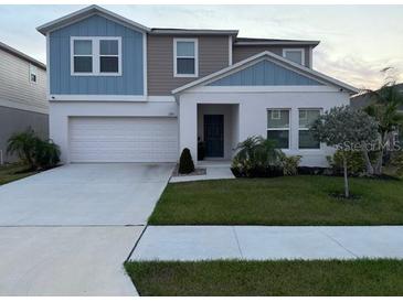Charming two-story home with a well-maintained front yard and attached two-car garage at 1393 Axel Cir, Winter Haven, FL 33880