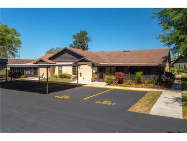 Charming single story home featuring a covered parking area and lush landscaping at 23 Kendra Ct, Winter Haven, FL 33880