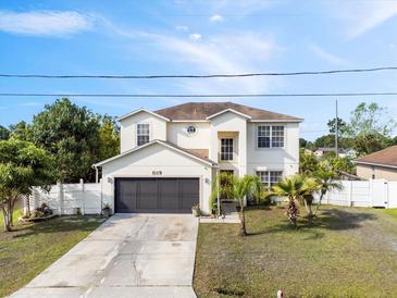 Charming two-story home with a two car garage, beautiful landscaping, and a well-maintained lawn at 247 Cobalt Dr, Kissimmee, FL 34758
