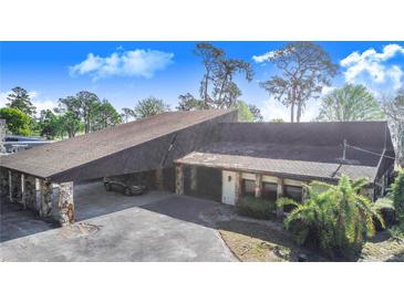 Unique home featuring a carport with stone columns and a spacious driveway at 2750 W Lake Hamilton Dr, Winter Haven, FL 33881