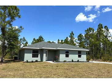 Charming single-story home with a well-manicured lawn and a classic design at 3120 Oleander Dr, Indian Lake Estates, FL 33855