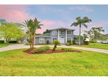 Stunning two-story home featuring a circular driveway and meticulously maintained landscaping at 329 Hamilton Shores Ne Dr, Winter Haven, FL 33881