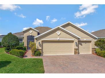 Inviting home featuring a three-car garage and meticulously maintained landscaping at 3710 Plymouth Dr, Winter Haven, FL 33884