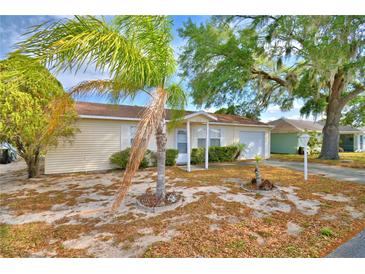 Charming single-story home featuring a well-maintained lawn and inviting curb appeal with palm tree at 4229 Nandina St, Lake Wales, FL 33898
