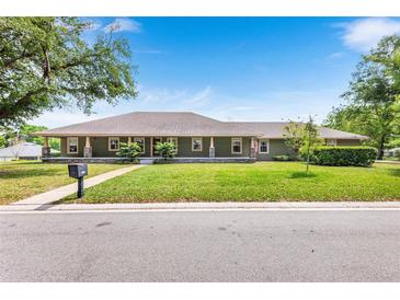 Charming single-story home with a welcoming front porch and well-manicured lawn, creating inviting curb appeal at 5020 Broadmore Dr, Auburndale, FL 33823