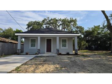 Charming single-story home featuring neutral paint, black shingle roof and decorative stone accents at 615 Avenue S Ne, Winter Haven, FL 33881