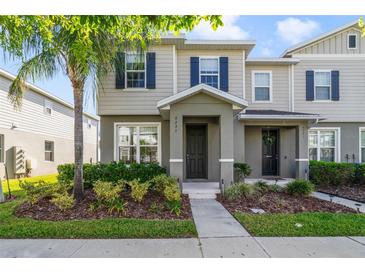 Charming two-story home with inviting front porch, blue shutters, and well-manicured landscaping at 6237 Aralia Ivy Ln, Winter Garden, FL 34787