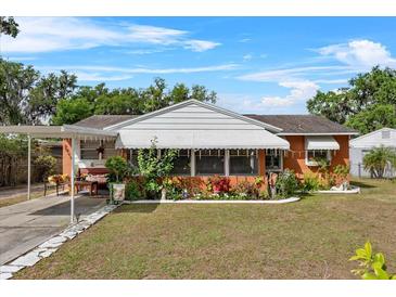 Charming single-story home with cozy porch and lush, landscaped front yard, perfect for relaxed outdoor living at 903 S Lakeview Ave, Bartow, FL 33830