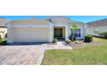 Charming one-story home featuring a well-manicured lawn and a neatly paved driveway at 916 Balmoral Dr, Davenport, FL 33896
