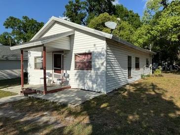 Charming single-story home featuring a covered porch and a well-maintained yard at 1109 Neville Ave, Lakeland, FL 33805