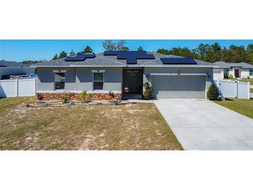 Charming single-story home with solar panels and well-manicured lawn at 229 Elm Ct, Kissimmee, FL 34759