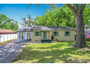 Charming single-story home featuring a well-maintained lawn and a covered parking area at 320 S Elm Rd, Lakeland, FL 33801