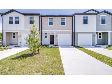 Charming townhome featuring a one-car garage and a well-maintained lawn at 3269 Vesara, Davenport, FL 33837