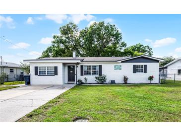 Charming single-story home with a well-maintained lawn and lovely landscaping at 612 Ralph St, Auburndale, FL 33823