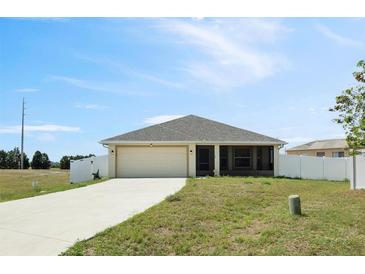 Charming single-story home with a well-manicured lawn, attached garage, and a classic design at 730 Colville Pl, Kissimmee, FL 34759