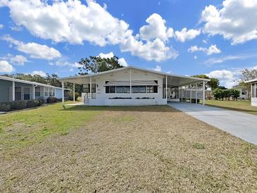 Charming single-story home with white exterior, covered porch, and well-maintained lawn at 1534 Longbow Dr, Lakeland, FL 33810