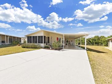 Charming single-story home featuring a screened-in porch and covered carport perfect for outdoor living and parking at 1746 Fox Hill Dr, Lakeland, FL 33810