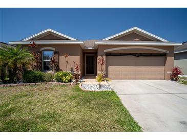 Charming one-story home boasts a well-manicured lawn and colorful landscaping at 249 Haines Blvd, Winter Haven, FL 33881