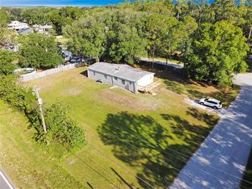 This home offers ample land with large green spaces perfect for outdoor activities and a cozy front deck at 3611 Island Oaks Ct, Lakeland, FL 33805