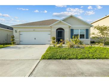 Charming single-story home featuring a well-maintained lawn and a two-car garage with driveway at 4333 Pumice Dr, Lakeland, FL 33811
