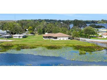 Waterfront home on large lot with lush landscaping and mature trees providing privacy at 553 Thornburg Rd, Babson Park, FL 33827