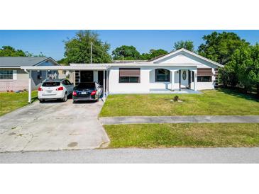 Charming single-story home featuring a carport and well-maintained front lawn at 608 William Ave, Winter Haven, FL 33880