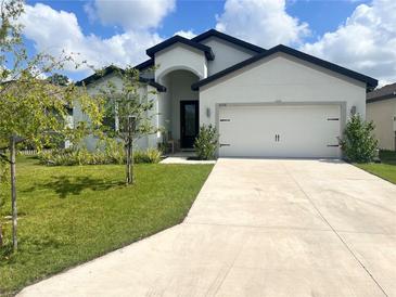 Charming single-story home with a well-manicured lawn and a two-car garage at 6316 Dolostone Dr, Lakeland, FL 33811