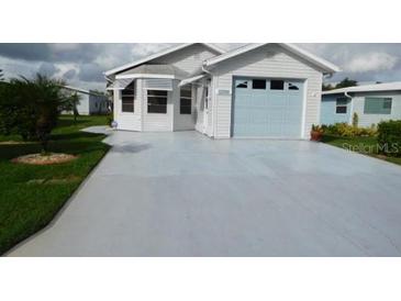 Charming single-story home features a one-car garage and well-manicured front lawn at 6398 Lolly Bay Ne Loop, Winter Haven, FL 33881