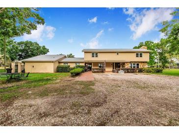 Charming two-story home featuring a spacious front yard and brick pathway leading to the entrance at 1646 Tyner Rd, Haines City, FL 33844