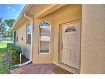 Inviting front entrance with a brick pathway and white front door at 1674 Linz Ct, Winter Haven, FL 33884