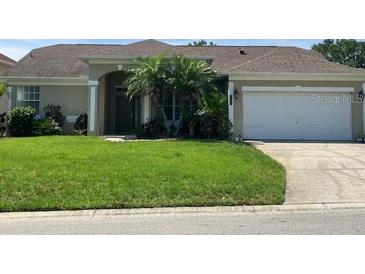 Charming single-story home with a well-manicured lawn and mature trees at 1681 Waterview Loop, Haines City, FL 33844