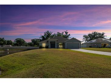 Charming one-story home with a well-manicured lawn and a two-car garage at 230 Cove At Eagle Lake Cir, Eagle Lake, FL 33839