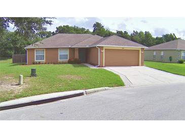 Charming single-story home featuring a well-maintained lawn, a driveway, and an attached two-car garage at 3430 Hilson Dr, Lakeland, FL 33812