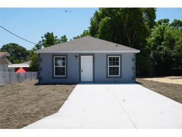 Charming single-story home featuring a freshly painted exterior, a new roof, and a neatly paved driveway at 3434 Avenue E Nw, Winter Haven, FL 33880