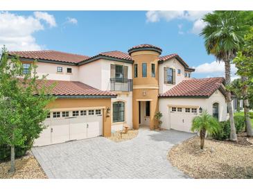 Stunning two-story home boasting a circular tower, three-car garage, and a beautiful tiled roof at 3833 Bowfin Trl, Kissimmee, FL 34746